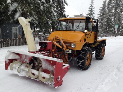 A rear mount snow blower I modified to fit on the front.